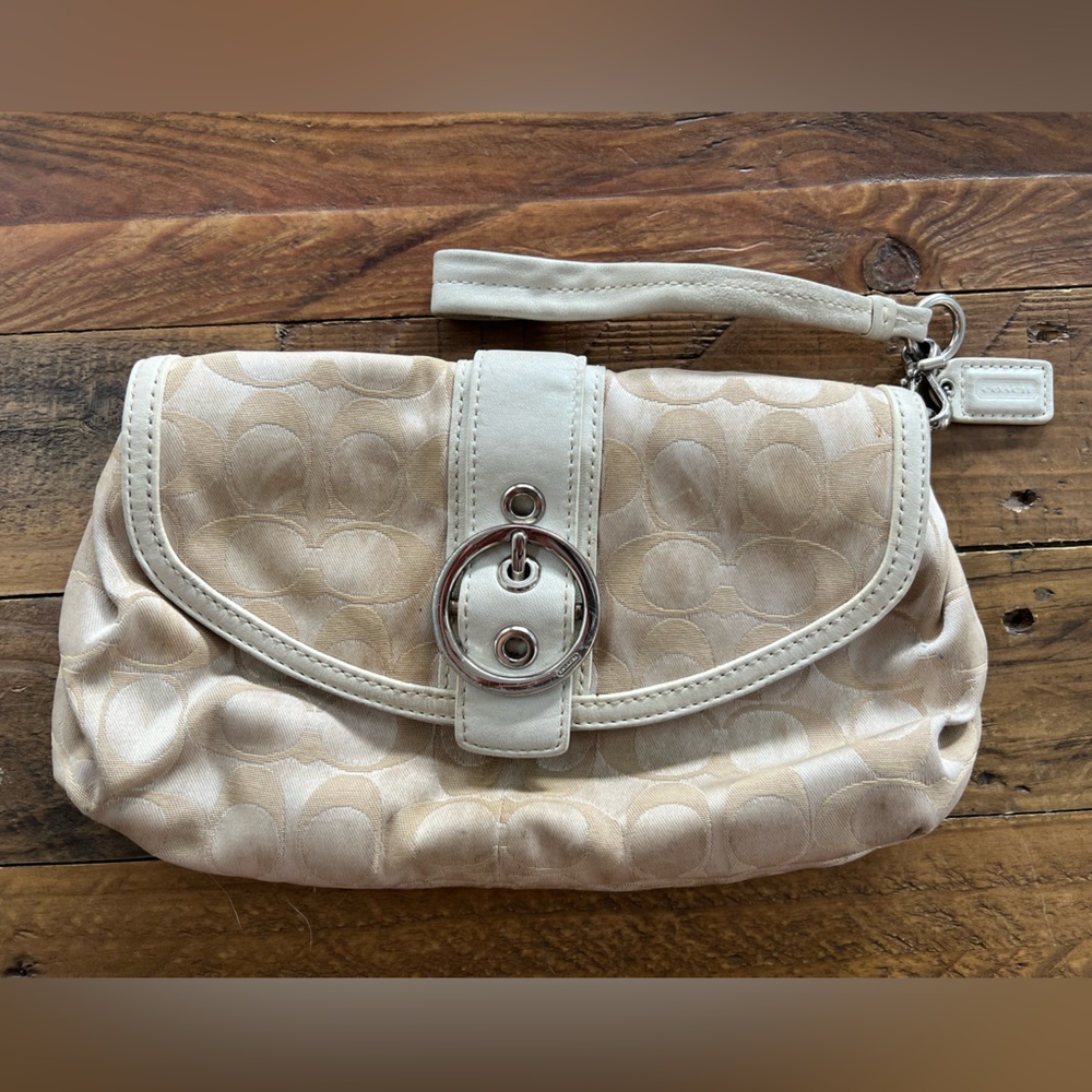 Coach cream colored wristlet/clutch with buckle clasp